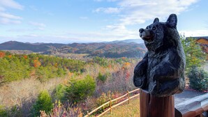 A bear statue overlooking a scenic landscape with mountains and autumn foliage. - Hot Tub + Games! Mtn-view Cabin Near Pigeon Forge (Sevierville)