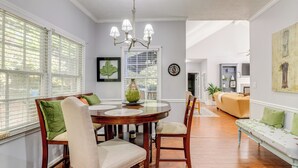 A dining area with a wooden table, chairs, and a chandelier. - ~ 30 Mi to Atlanta - The Wellness Manor w/ Deck! (Snellville)