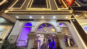 A hotel entrance with a modern design, featuring a prominent sign and a well-lit facade. - Hotel Lotus Arc (New Delhi)