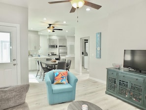 A modern living room with a sofa, a television, and a cabinet.