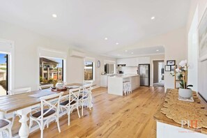 Enjoy a modern space with a dining table, central island, and kitchen area.