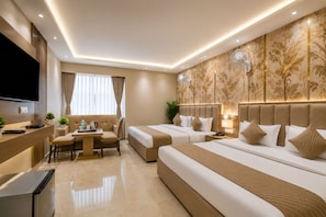 A hotel room with a bed, bedside tables, a desk with a chair, a TV, and a large window with curtains.