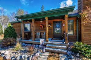 A wooden cabin with a porch, a welcome sign, and a wreath. - Cabin in Lakewood right on Snowmobile Trails! (Lakewood)