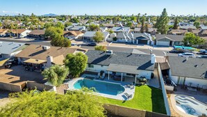 A residential area with houses, a swimming pool, and a clear sky. - 3 Bedrooms/2 Bath, Pool & Hot Tub, King Beds, Full Kitchen, Garage, EV Charger (Tempe)