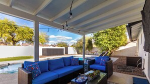 A covered outdoor seating area with a pool, wicker furniture, and a hammock. - 3 Bedrooms/2 Bath, Pool & Hot Tub, King Beds, Full Kitchen, Garage, EV Charger (Tempe)