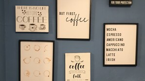 A wall with various framed coffee-themed signs. - 2 Bdrm 2bath Downtown Permit # 4768 (Palm Springs)
