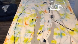 A painting with abstract shapes and splashes of yellow, green, and white on a rectangular canvas. - 2 Bdrm 2bath Downtown Permit # 4768 (Palm Springs)