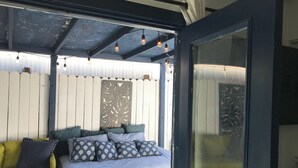 A bedroom with a bed, a sofa, and a decorative panel on the wall. - 2 Bdrm 2bath Downtown Permit # 4768 (Palm Springs)