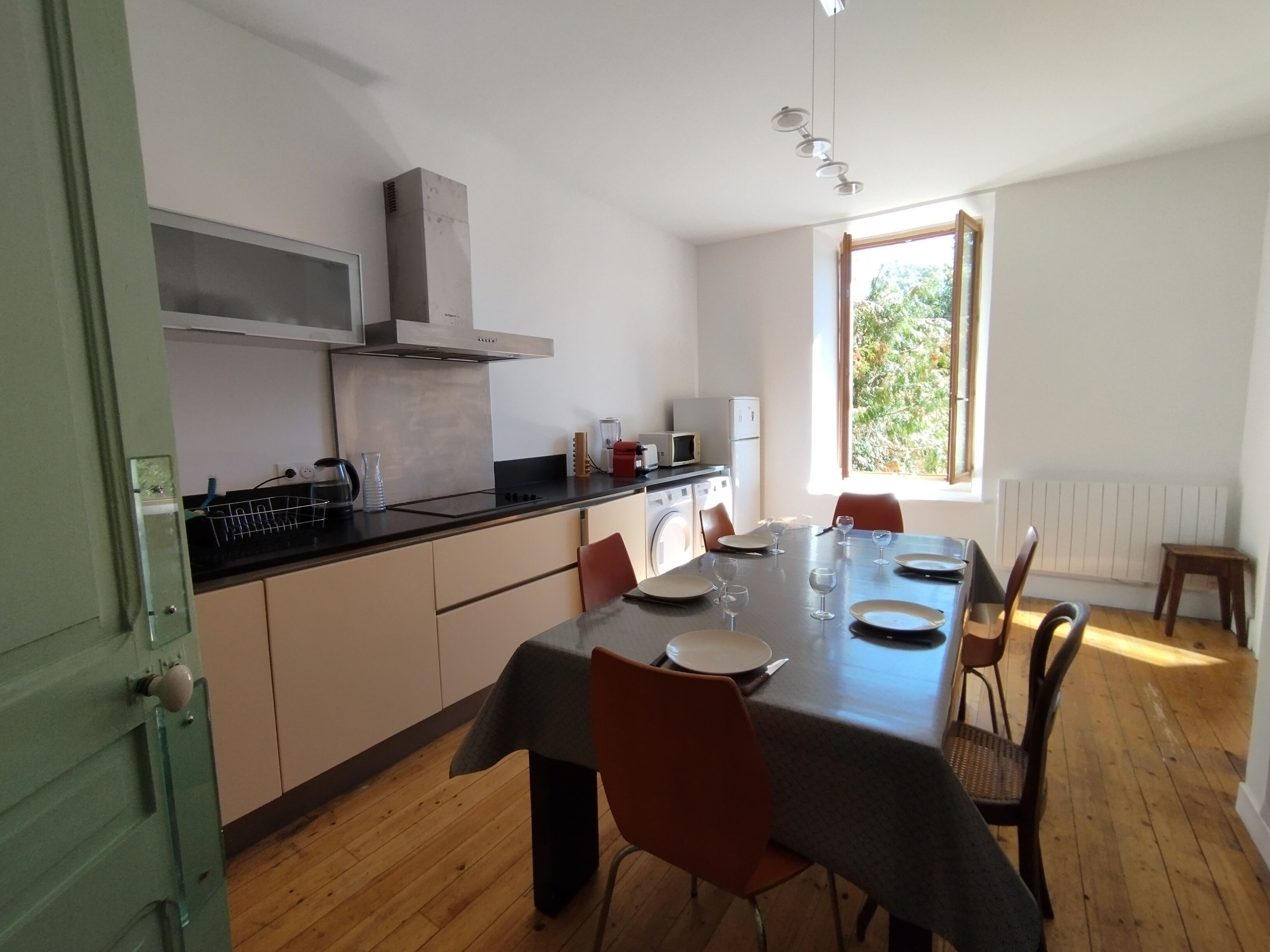 A modern kitchen with a dining area.