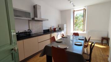A modern kitchen with a dining area.
