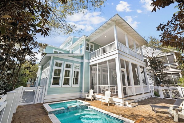 A two-story house with a pool, white railings, and a covered patio area. - Magnolia Way|Private Community Beach Access|Watercolor Home w/ Private Pool (Watercolor)
