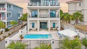 A multi-story residential building with a swimming pool, balconies, and outdoor seating. - It's About Time|Unobstructed Gulf Views|Private Pool|Gated Community (Seacrest)
