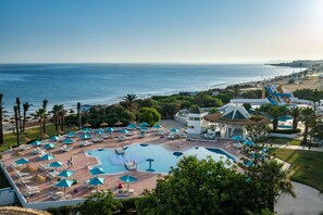 A resort with a large pool, sun loungers, umbrellas, and a view of the sea. - Vincci Helya Beach (Monastir)