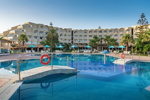 A hotel pool area with a clear blue pool, lounge chairs, umbrellas, and a lifebuoy. - Vincci Helya Beach (Monastir)