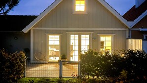 A two-story house with a gabled roof, a front porch, and a fenced backyard. - 5 Star Holiday Home in Brenderup Fyn (Middelfart)