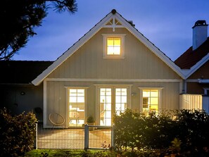 A two-story house with a gabled roof, a front porch, and a fenced backyard. - 5 Star Holiday Home in Brenderup Fyn (Middelfart)