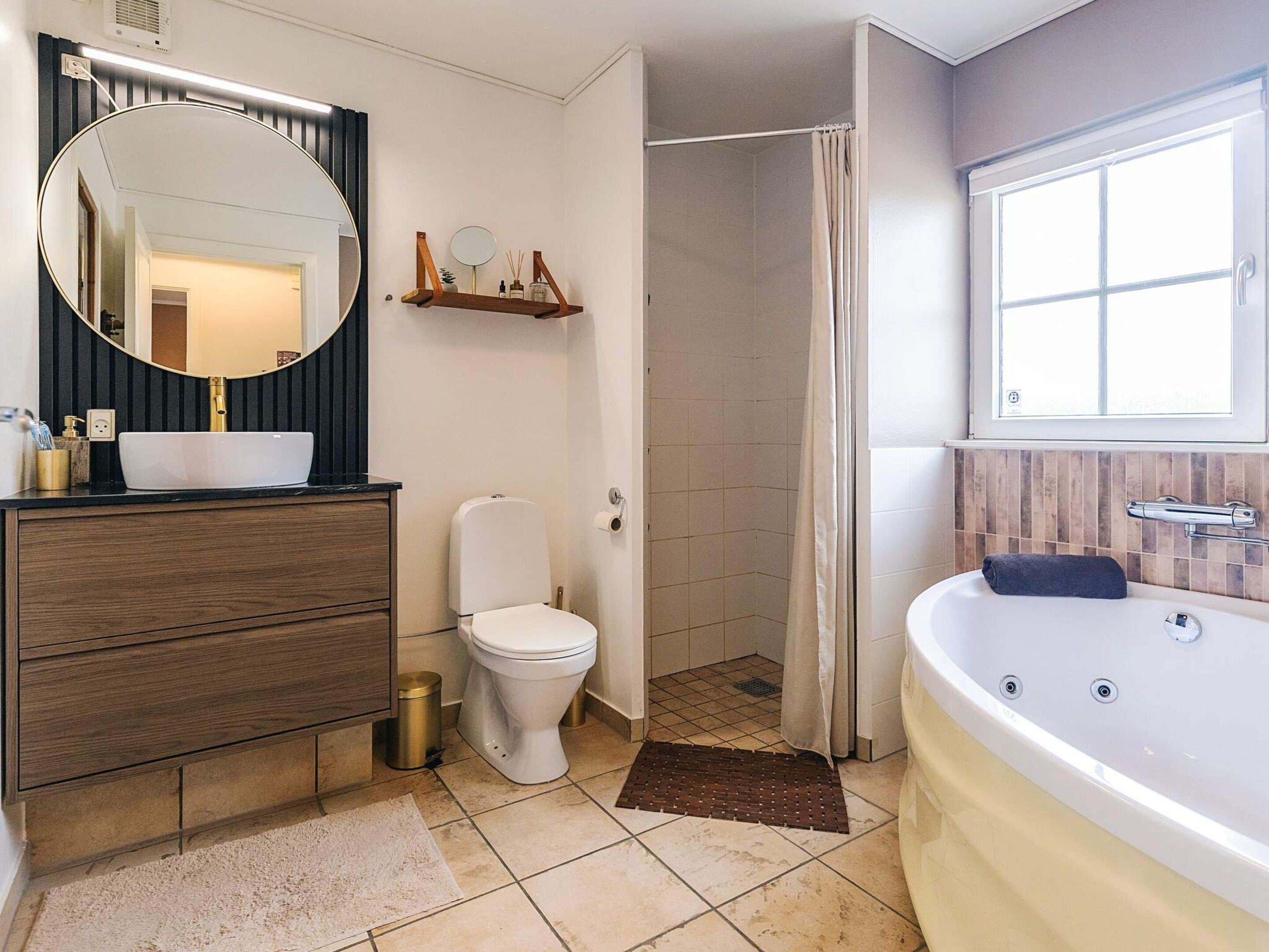 Un baño con tocador, inodoro, ducha y bañera.