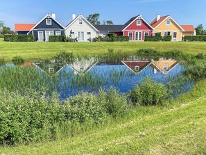 A row of houses with a pond in front. - 5 Star Holiday Home in Brenderup Fyn (Middelfart)