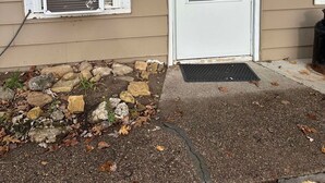 A house with a white front door, a window with a 'No Smoking' sign, and a small stone pathway leading to the door. - Woodland Retreat next to the Mississippi River (Alma)
