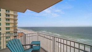 Ein Balkon mit Blick auf Strand und Meer.