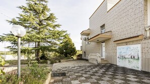 A building with a checkered floor, a door, and a staircase leading to a balcony. - Agriturismo Liscio by Rentbeat (Noci)