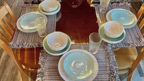 A dining table set with plates, glasses, and a centerpiece. - Spacious Sequoia Park 5 bed 3 bath house w/ AC & WIFI in charming Three Rivers (Three Rivers)