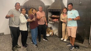 A group of people in a room with a brick oven and stone floor. - Hotel La planicie -Pico Alto (Punta Hermosa)