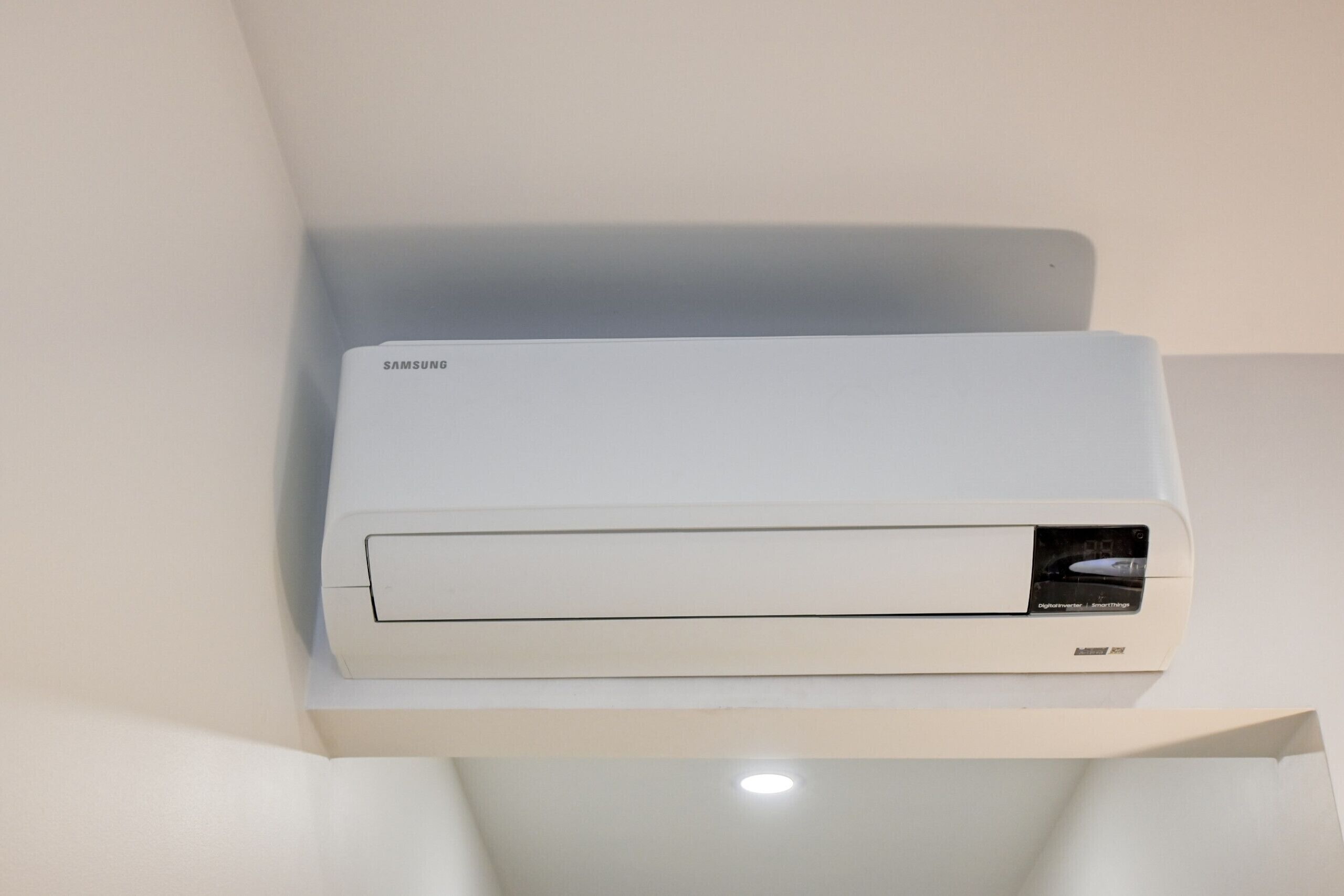 A Samsung air conditioner mounted on a white wall.