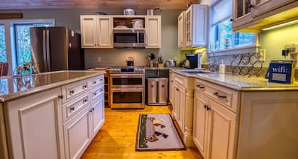 The 4 Seasons on Mooselookmeguntic Lake with dock, mooring, 4 kayaks, fire pit, and pet friendly!