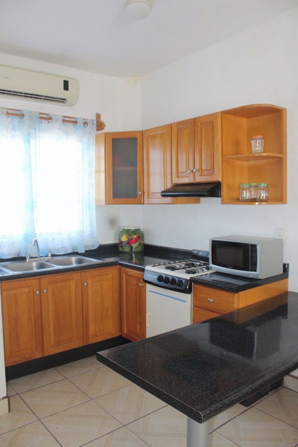 Fridge, microwave, coffee/tea maker, cookware/dishes/utensils