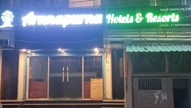 A building with a sign for "Hotel & Resorts" and another sign for "Transport Service." - Arnnapurna Hotels & Resorts (Jajapur)