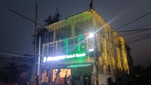 A building with a green sign and yellow lights. - Arnnapurna Hotels & Resorts (Jajapur)