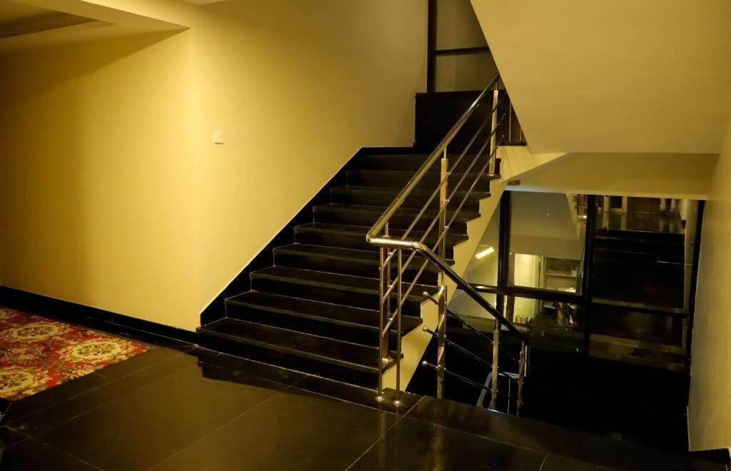 A staircase with a glass railing leading to a lower level.