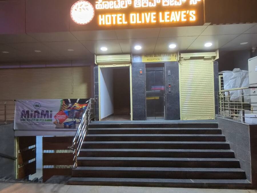 The entrance to Hotel Olive Leaves with a sign indicating the reception is on the 3rd floor.
