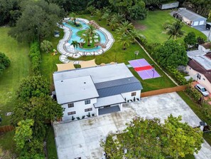 Enjoy a tranquil retreat with a patio, lawn, and garden, plus a swimming pool and tennis court.