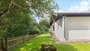 A pathway leading to a building with a white exterior and a tiled roof. - Vacation home with parking lot Pet-friendly in the ski area (Wildhaus-Alt Sankt Johann)