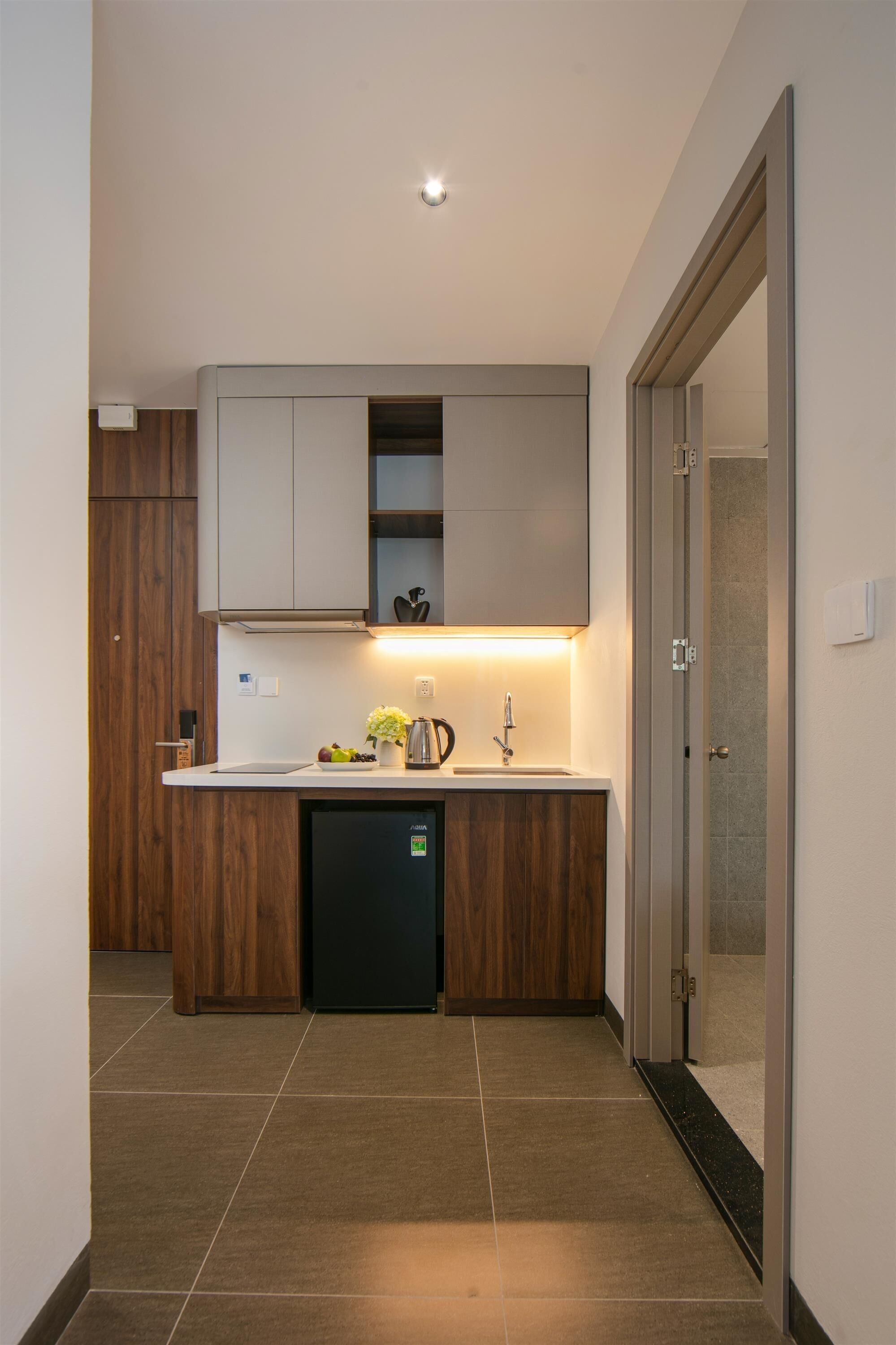 A modern kitchen with a built-in dishwasher, wooden cabinets, and a stainless steel sink.