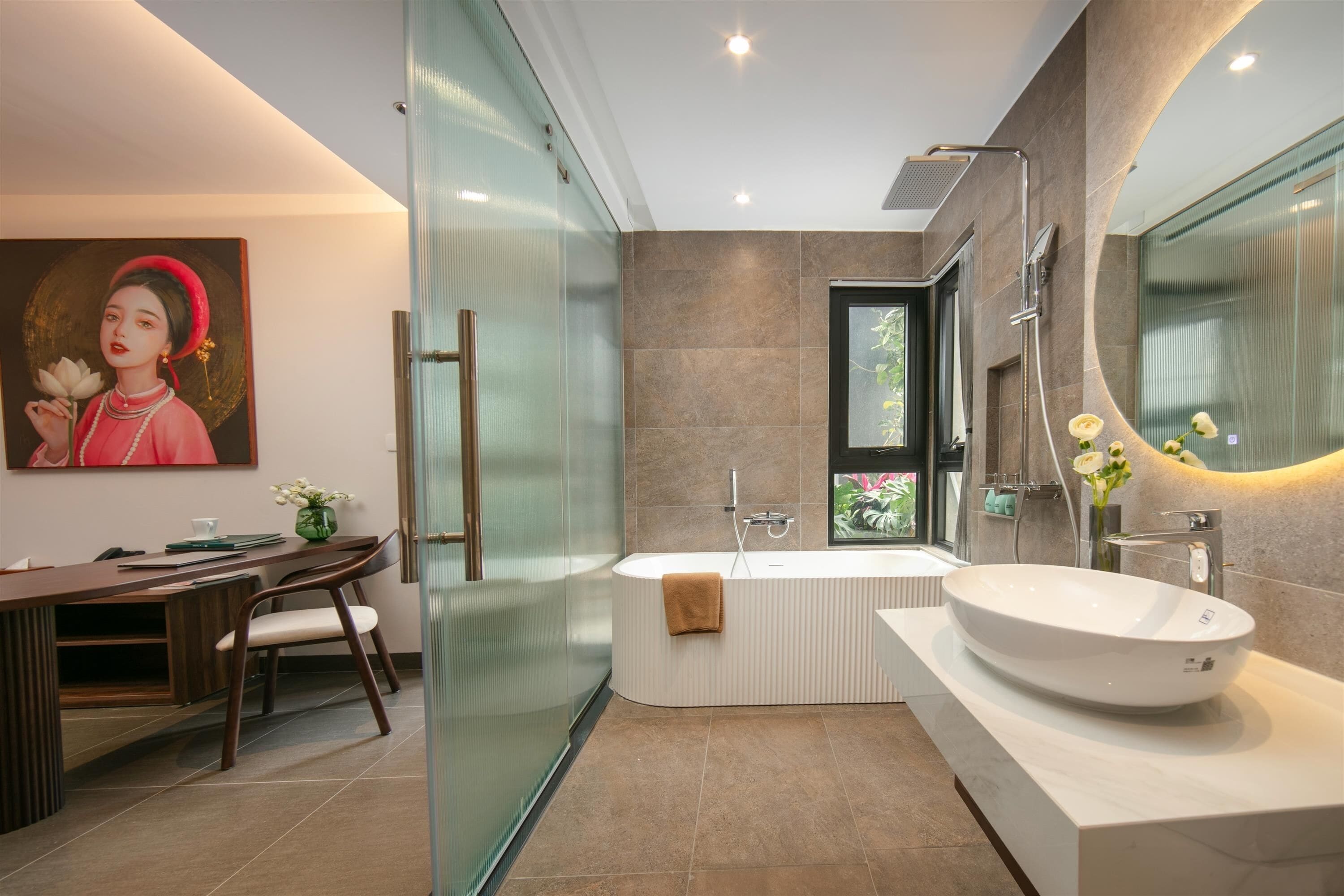 A modern bathroom with a large bathtub, a glass shower enclosure, and a vanity with a large mirror.