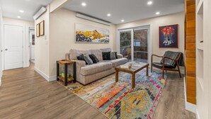 A spacious living room with a sofa, coffee table, and a colorful rug. - New | Prime Location | Skier`s Paradise (Avon)