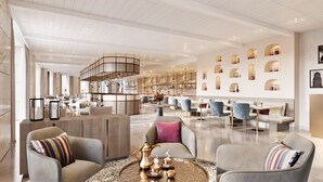 A spacious hotel lobby with a central seating area, a bar, and a dining area. - Makarem Burj Al Madinah Hotel and Suites (Madinah)