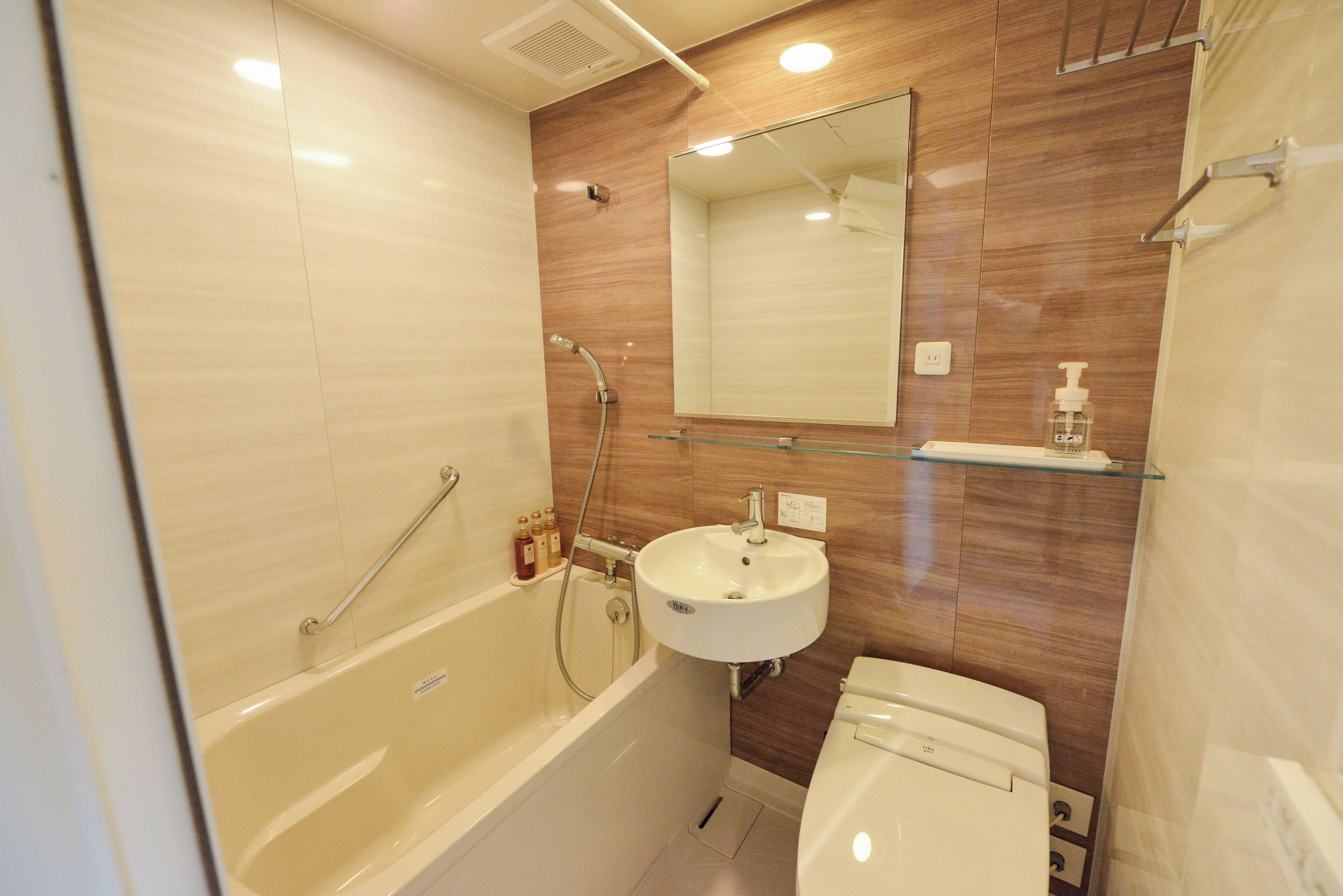 A compact bathroom with a bathtub, a sink, and a toilet.