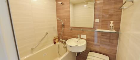 A compact bathroom with a bathtub, a sink, and a toilet.