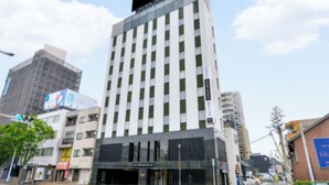 A modern building with a prominent vertical design, large windows, and a flat roof.