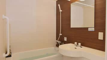 A bathroom with a bathtub, a sink, and a mirror.