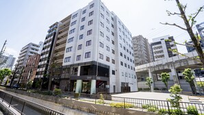A modern hotel with multiple floors, a prominent entrance, and a parking area. - Hotel New Gaea Yakuin (Fukuoka)