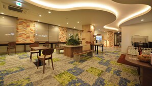 A hotel lobby with seating areas, a reception desk, and a patterned carpet. - Hotel New Gaea Nishi Kumamoto Ekimae (Kumamoto)