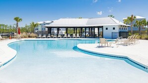 A swimming pool with lounge chairs and a covered pavilion. - Coastal Bummz | Pets | Walk to Beach & Pool (Orange Beach)