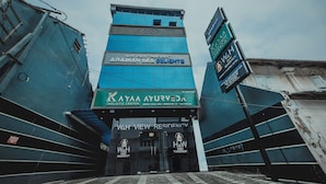 A hotel entrance with signage for WH Restaurant Arabian Sea Delights and AYAA Ayurveda Holistic Center. - W & H View Residency (Kochi)