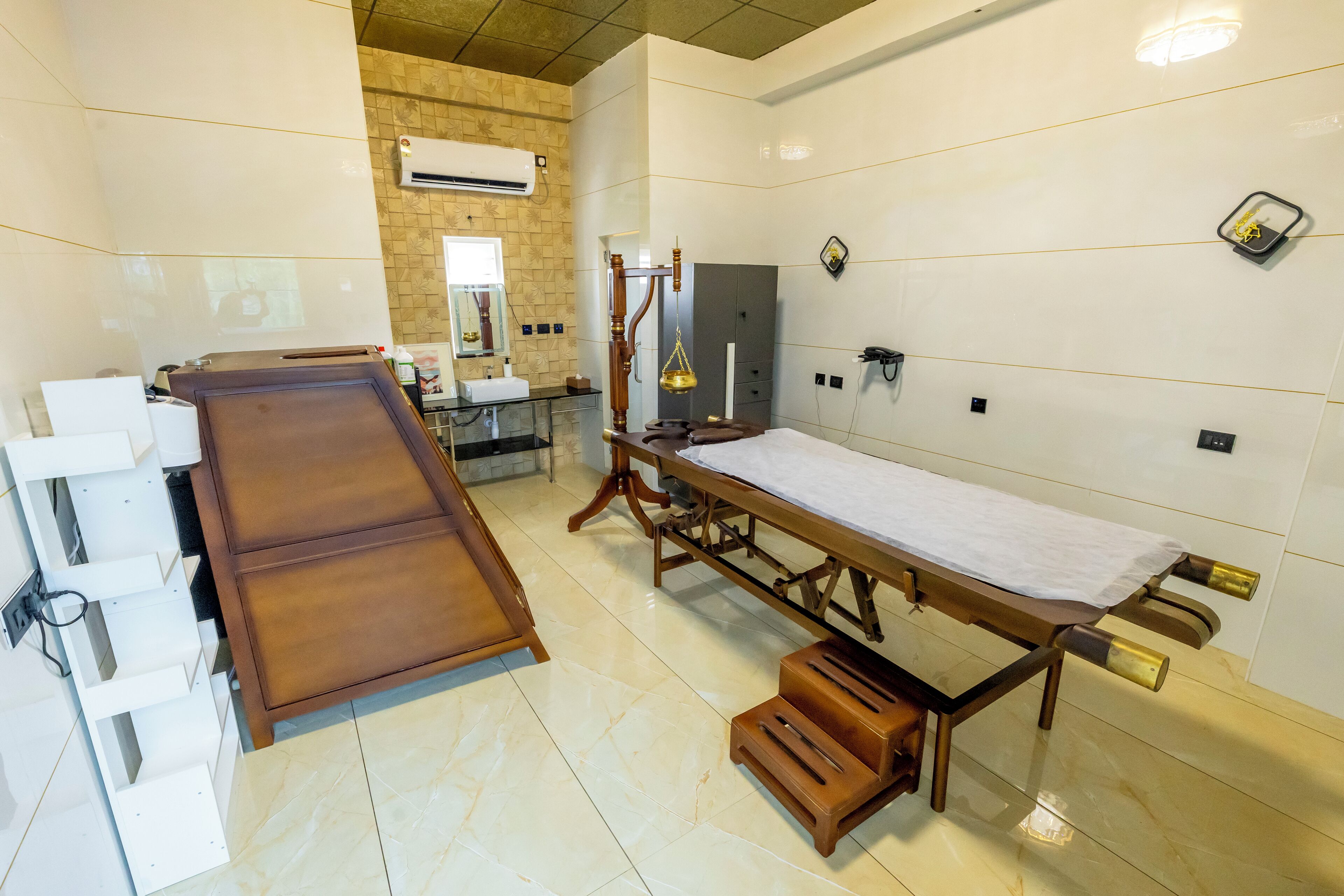 A hospital room with a wooden bed, a sink, and a mirror.