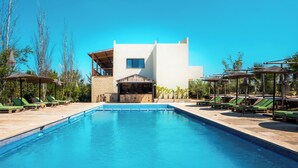 A swimming pool with lounge chairs and umbrellas, a barbecue area, and a building with a white facade. - Bio et bois - Luxury Bio farm (Ain Chkef)
